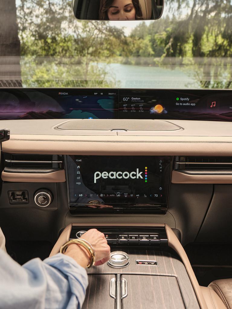 L’intérieur d’un Lincoln Black Label Navigator 2026 avec une application de diffusion en continu affichée sur l’écran de la console centrale